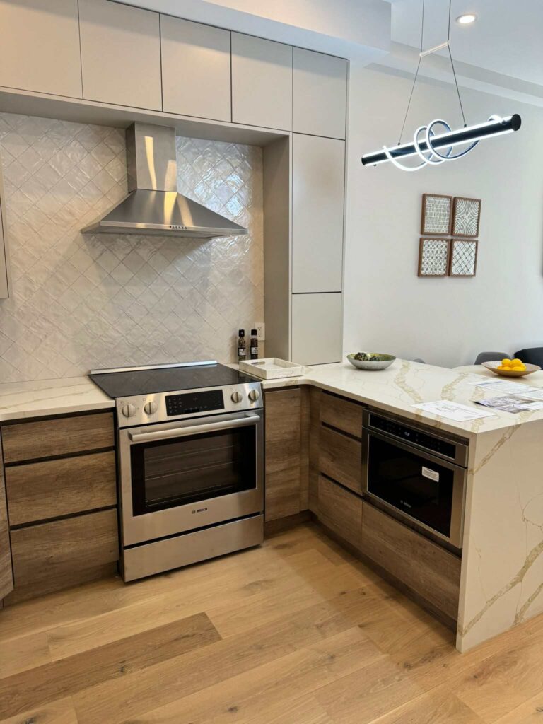 Contemporary kitchen design with custom cabinets, island, and lighting in a Brooklyn home